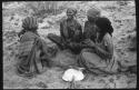 Group of women sitting and playing a dandiri
