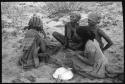 Group of women sitting and playing a dandiri
