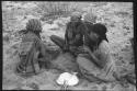 Group of women sitting and playing a dandiri
