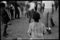 School boys playing a game; a group watching from the side (image out of focus)