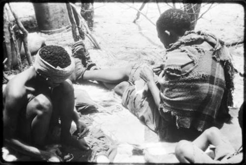 Dadum and Tama sitting and working on beadwork and sewing (copy of color slide 2001.39.8366)