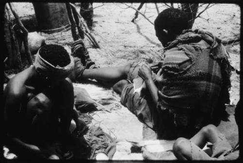 Dadum and Tama sitting and working on beadwork and sewing (copy of color slide 2001.39.8366)