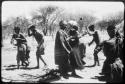 Group of people performing the Eland Dance, including two men wearing horns (copy of color slide 2001.29.8653)