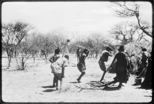 Group of people performing the Eland Dance, including three men wearing horns (copy of color slide 2001.29.8652)