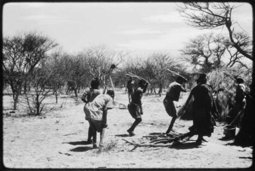 Group of people performing the Eland Dance, including three men wearing horns (copy of color slide 2001.29.8652)