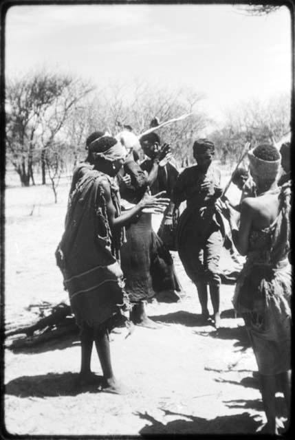 !Ani dancing and passing through a line of women standing and clapping (copy of color slide 2001.29.8655)