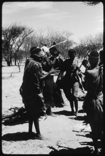 !Ani dancing and passing through a line of women standing and clapping (copy of color slide 2001.29.8655)