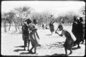 Dancers performing the Eland Dance, with Twi playing up to !Ani (copy of color slide 2001.29.8659)