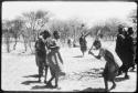 Dancers performing the Eland Dance, with Twi playing up to !Ani (copy of color slide 2001.29.8659)