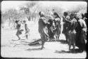 Group of women dancing, with little girls dancing behind them (copy of color slide 2001.29.8662)