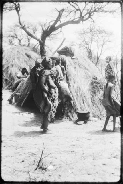 Group of people performing the Eland Dance in front of a skerm (copy of color slide 2001.29.8676)