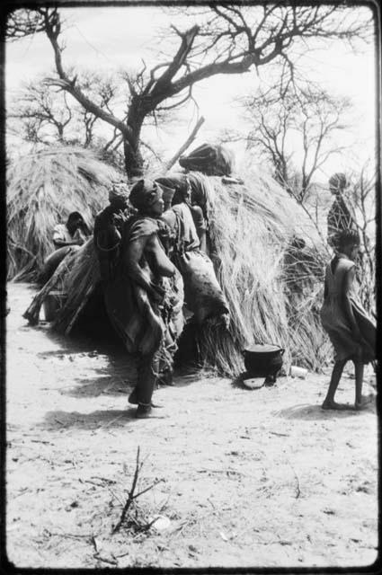 Group of people performing the Eland Dance in front of a skerm (copy of color slide 2001.29.8676)