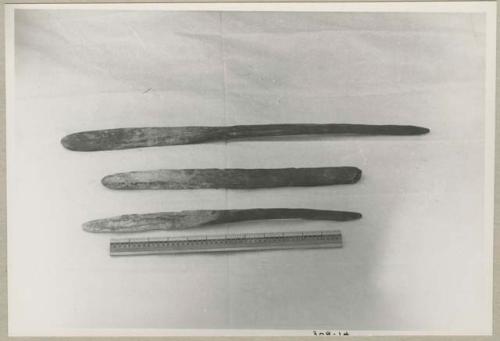 Implements displayed with a ruler for measurement (print is a cropped image)