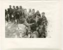 Group of women talking with Lorna Marshall and Elizabeth Marshall Thomas, and receiving tobacco from them (print is a cropped image)