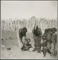 Women and children standing inside their kraal