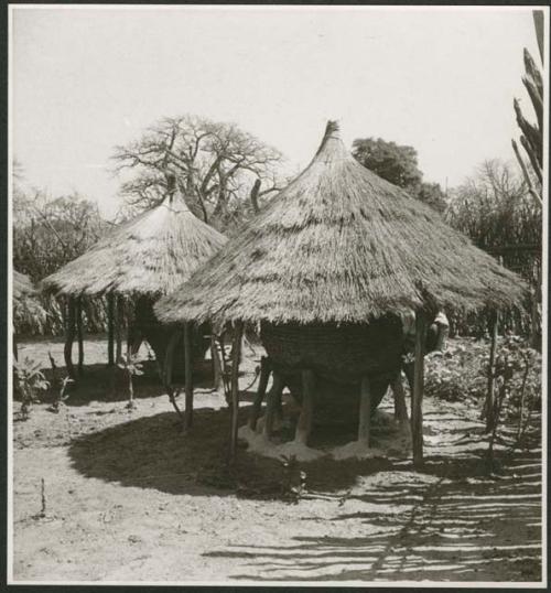 Two storage baskets with thatched roofs