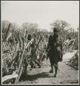 Two women walking inside their kraal