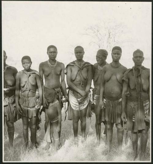 Women standing in a circle, and clapping, singing and taking turns dancing