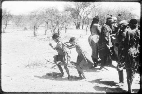 Two little girls dancing next to a group of women (copy of color slide 2001.29.8661)