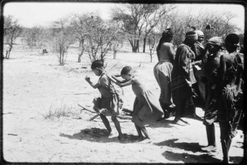 Two little girls dancing next to a group of women (copy of color slide 2001.29.8661)