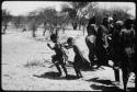 Two little girls dancing next to a group of women (copy of color slide 2001.29.8661)