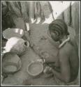 Woman sitting and making a pot