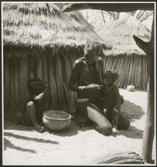 Elderly woman feeding two children