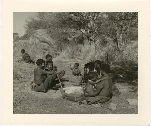 /Naoka, first wife of /Ti!kay, performs a choa ceremony for her daughter, Bau, wife of Tsamgao, distant view (print is a cropped image)