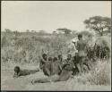 Group of Ju/'hoansi telling stories including "Lame ≠Gao," ≠Gao (Khwo//o's-/Gasa's husband), "Gao Medicine," an unidentified person, ≠Toma, !Naishi, "Old Xama," "Gao Helmet," "Old Demi" lying down, "Crooked /Qui," Gao (Debe's son, Zuma's husband), and ≠Toma (!Naishi's son) (print is a cropped image)