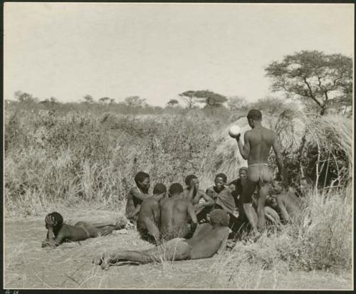 Group of Ju/'hoansi telling stories including "Lame ≠Gao," ≠Gao (Khwo//o's-/Gasa's husband), "Gao Medicine," an unidentified person, ≠Toma, !Naishi, "Old Xama," "Gao Helmet," "Old Demi" lying down, "Crooked /Qui," Gao (Debe's son, Zuma's husband), and ≠Toma (!Naishi's son) (print is a cropped image)