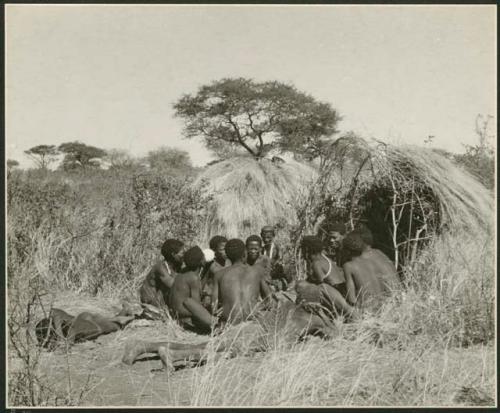 Group of Ju/'hoansi telling stories including "Lame ≠Gao," ≠Gao (Khwo//o's-/Gasa's husband), "Gao Medicine," an unidentified person, ≠Toma, !Naishi, "Old Xama," "Gao Helmet," "Old Demi" lying down, "Crooked /Qui," Gao (Debe's son, Zuma's husband), and ≠Toma (!Naishi's son) (print is a cropped image)