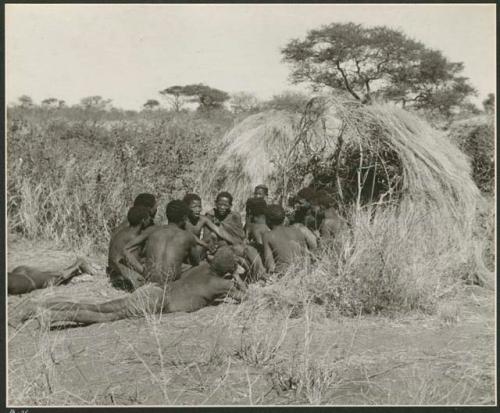 Group of Ju/'hoansi telling stories including "Lame ≠Gao," ≠Gao (Khwo//o's-/Gasa's husband), "Gao Medicine," an unidentified person, ≠Toma, !Naishi, "Old Xama," "Gao Helmet," "Old Demi" lying down, "Crooked /Qui," Gao (Debe's son, Zuma's husband), and ≠Toma (!Naishi's son) (print is a cropped image)