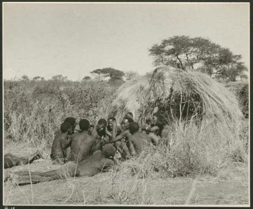 Group of Ju/'hoansi telling stories including "Lame ≠Gao," ≠Gao (Khwo//o's-/Gasa's husband), "Gao Medicine," an unidentified person, ≠Toma, !Naishi, "Old Xama," "Gao Helmet," "Old Demi" lying down, "Crooked /Qui," Gao (Debe's son, Zuma's husband), and ≠Toma (!Naishi's son) (print is a cropped image)