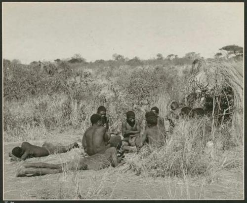 Group of Ju/'hoansi telling stories including "Lame ≠Gao," ≠Gao (Khwo//o's-/Gasa's husband), "Gao Medicine," an unidentified person, ≠Toma, !Naishi, "Old Xama," "Gao Helmet," "Old Demi" lying down, "Crooked /Qui," Gao (Debe's son, Zuma's husband), and ≠Toma (!Naishi's son) (print is a cropped image)