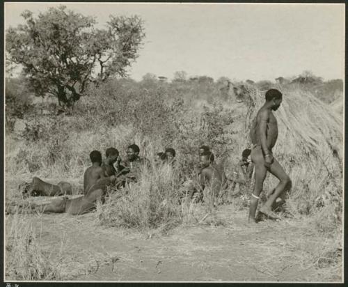 Group of Ju/'hoansi telling stories including "Lame ≠Gao," ≠Gao (Khwo//o's-/Gasa's husband), "Gao Medicine," an unidentified person, ≠Toma, !Naishi, "Old Xama," "Gao Helmet," "Old Demi" lying down, "Crooked /Qui," Gao (Debe's son, Zuma's husband), and ≠Toma (!Naishi's son) (print is a cropped image)