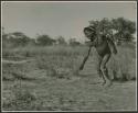 Boy pushing a toy car made from veldkos (print is a cropped image)