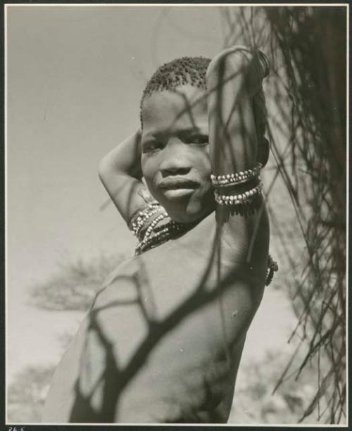 Boy holding his hands behind his head, portrait (print is a cropped image)