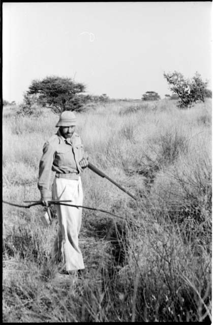 Robert Story standing and holding a gun