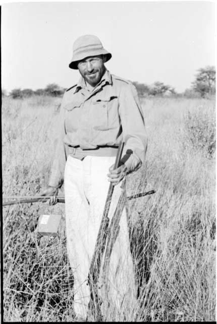 Robert Story standing and holding a gun