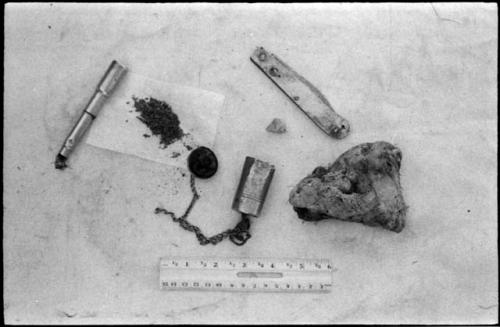 Pipe, tobacco, fire-striker and stone to make a spark, metal knife and fungus used as tinder, with a ruler for measurement