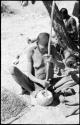 /Twikwe putting tsama melon seeds on sieve and in a bowl