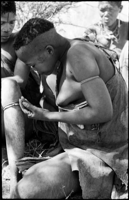 Woman visiting from Okwa, profile, close-up showing her haircut and scarification