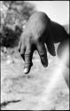 Person demonstrating the hunting hand signal for an unidentified animal