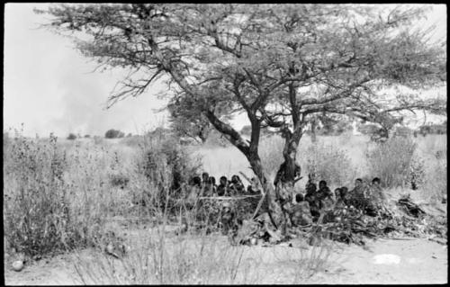 People from Oukwane's group and a band visiting from Okwa sitting in the shade in Oukwane's werft