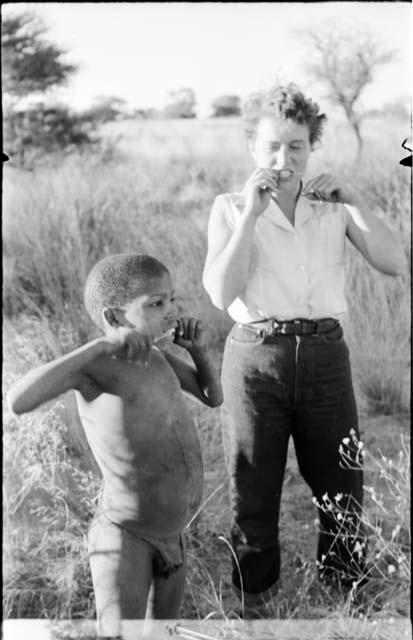 /Gaiamakwe and Elizabeth Marshall Thomas playing music with grass stems in their mouths