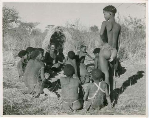 Group of men and boys playing a game, including "Gao Medicine," "Old Naishi" (headman of Band 5), and "≠Gao Lame" (standing)  (print is a cropped image)