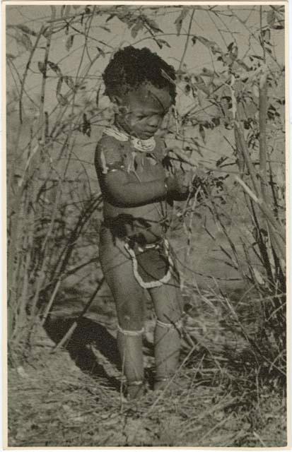 Little girl standing in the brush (print is a cropped image)