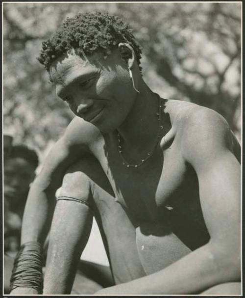 Man sitting, after throwing oracle disks (print is a cropped image)