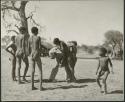 Group of boys playing with John Marshall, including /Gishay (son of "Old Gau"), ≠Toma (son of Gau), !Naishi, and //Ao (son of "Old ≠Toma" of Band 2) (print is a cropped image)