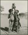 "Little ≠Gao" and Be (daughter of Bo) standing next to each other and holding gemsbok horns (print is a cropped image)